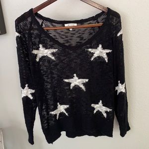 Women’s black sweater with white stars